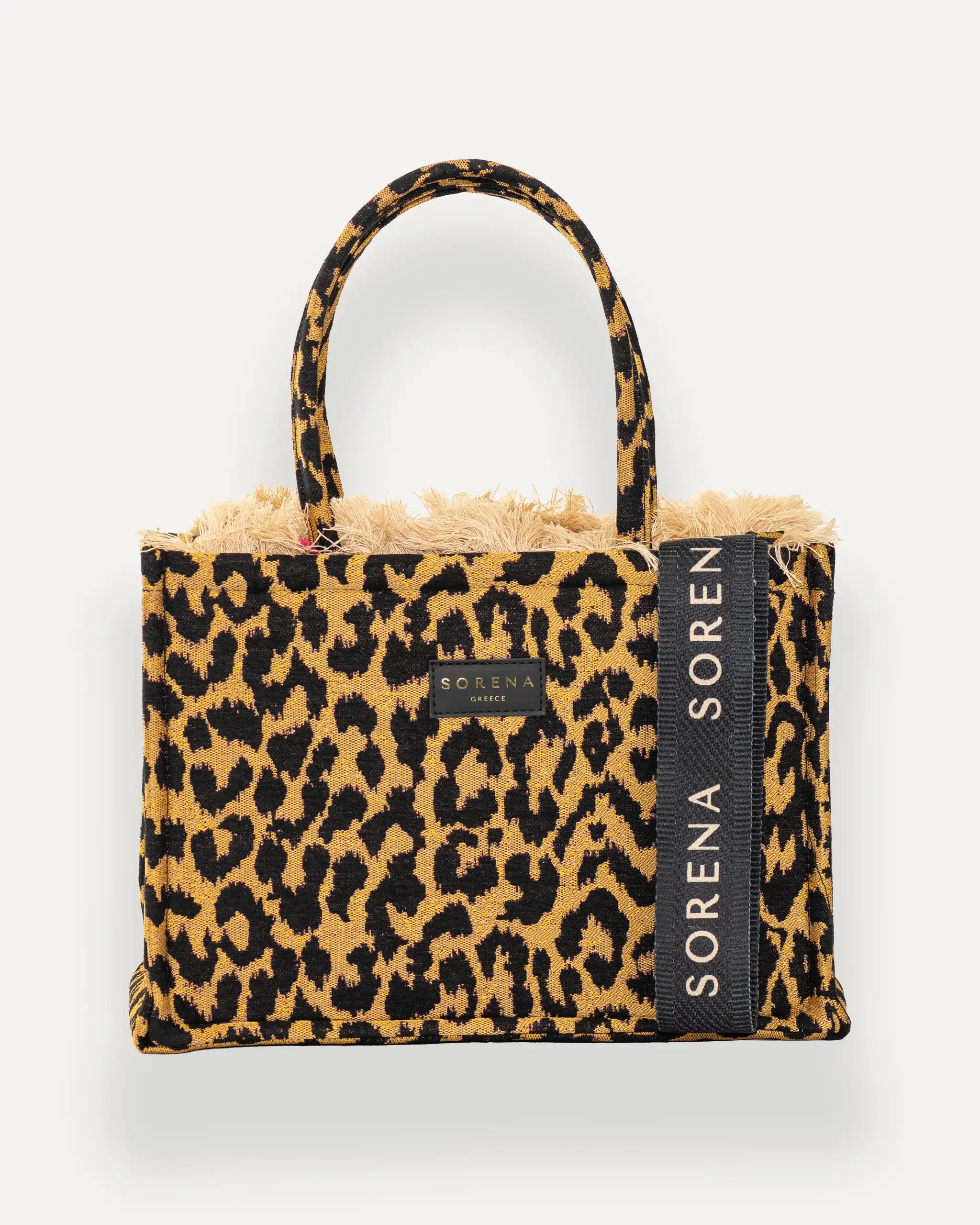 Frontansicht der Sorena Greece Medium Tote Bag – Leopard-Muster in Gelb und Schwarz, Fransen, Label und vertikales Branding sichtbar, hochwertige shopper tasche damen schweiz mit Designfokus.